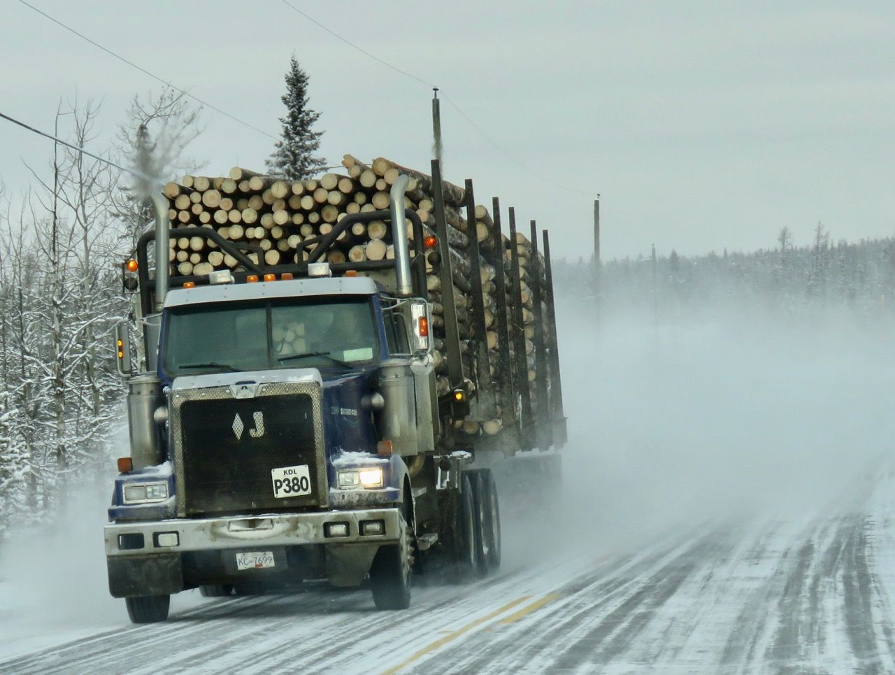 Premium AI Image | A Photo of a Durable Logging Truck Carrying Timber
