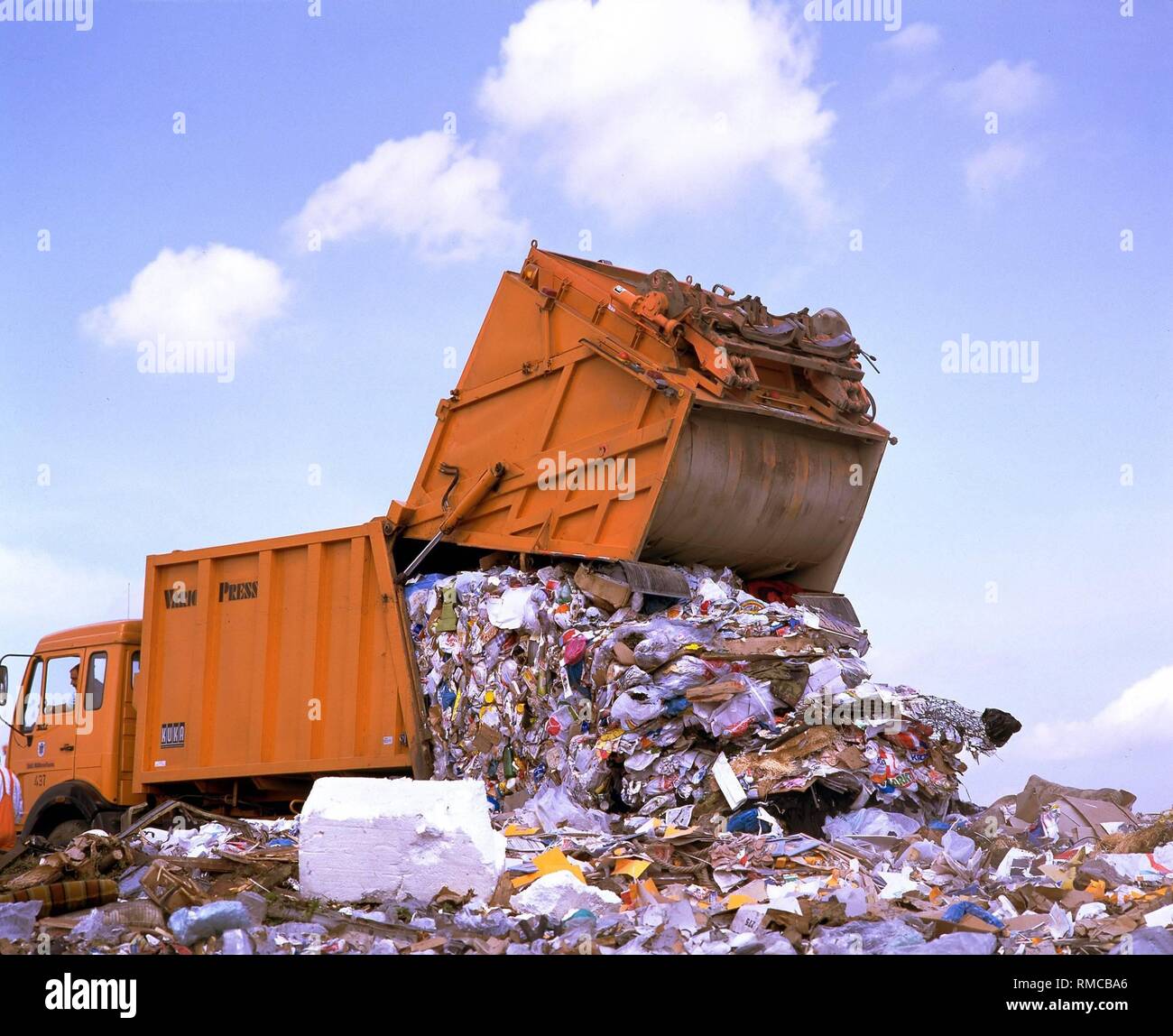 Garbage truck unloading waste at a garbage dump in North Rhine ...